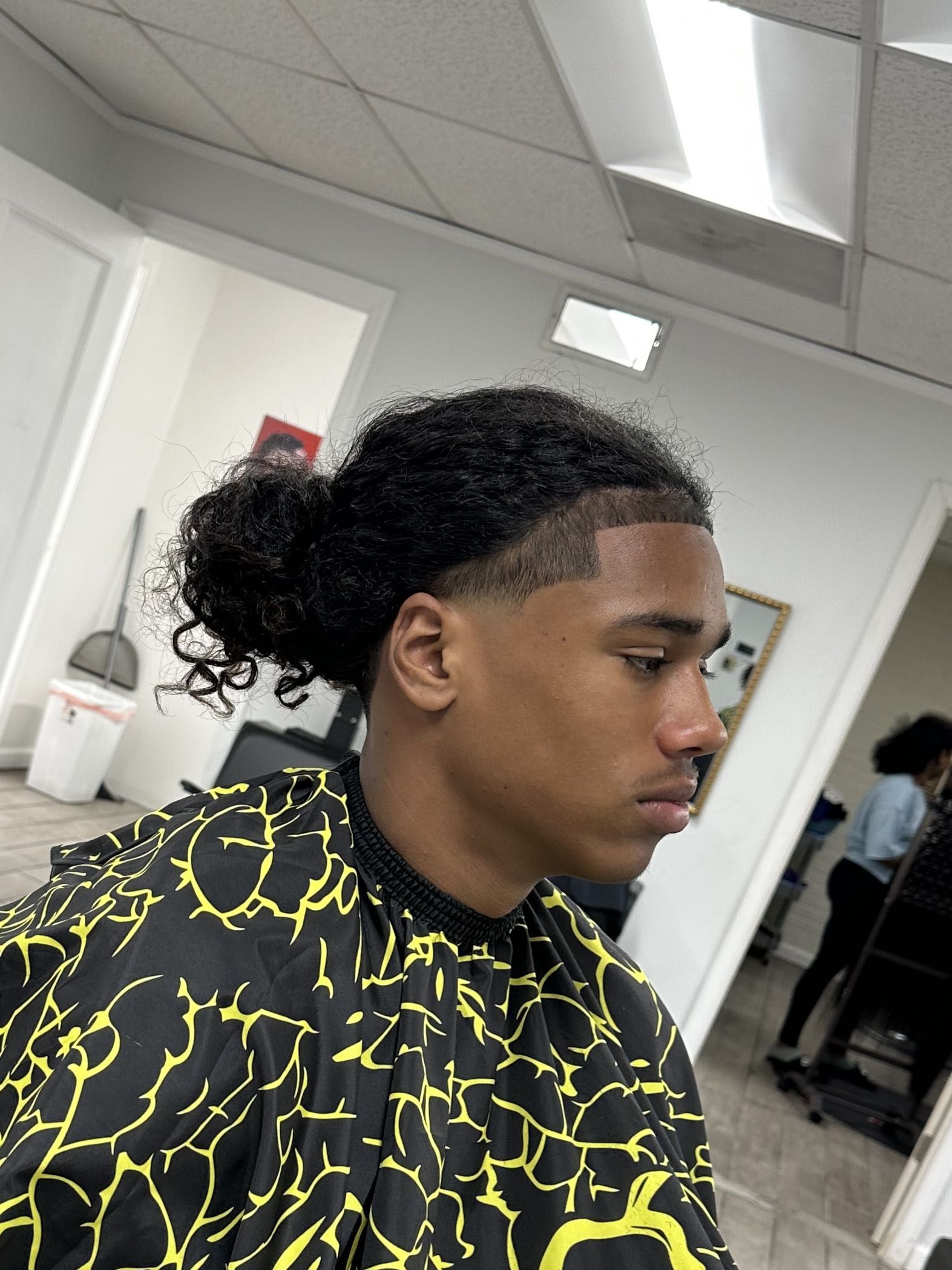 Curly bun with skin fade